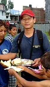 Pastor Reuben giving out food to young people in Nepal.