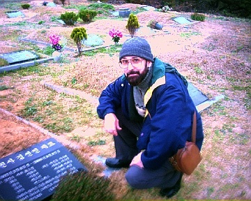 Ken Street in South Korea beside the graves of his wife's parents. They were both Christians.