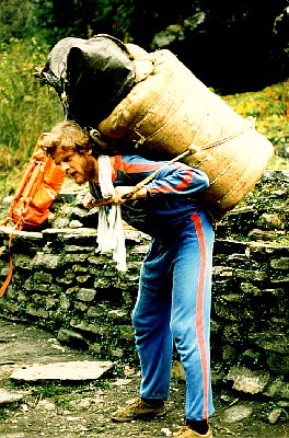1979 Nepal, Pokhara-Muktinath Trek. Werner tries lifting a Sherpa's giant backpack. Werner had some Swiss army training, so he could hold it up for a while. But the Sherpas are like supermen when it comes to carrying a heavy load. Photo by Ken Street.